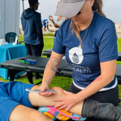 Heather Sweeney providing IASTM therapy for an athlete with knee problems.